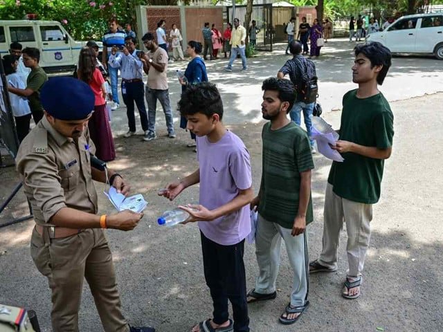 India holds re-exam under tight security following leak
